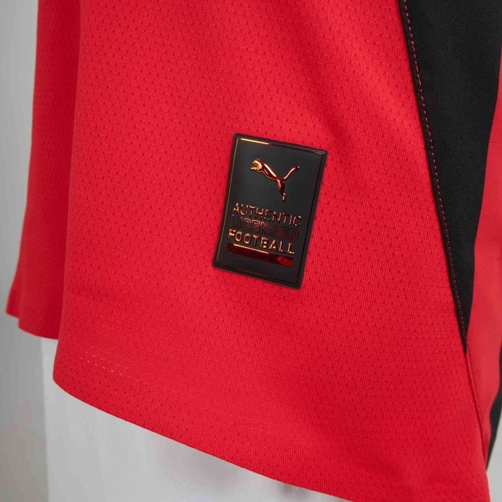 Close-up view of the AC Milan 2024 jersey featuring the Puma logo and authentic football badge