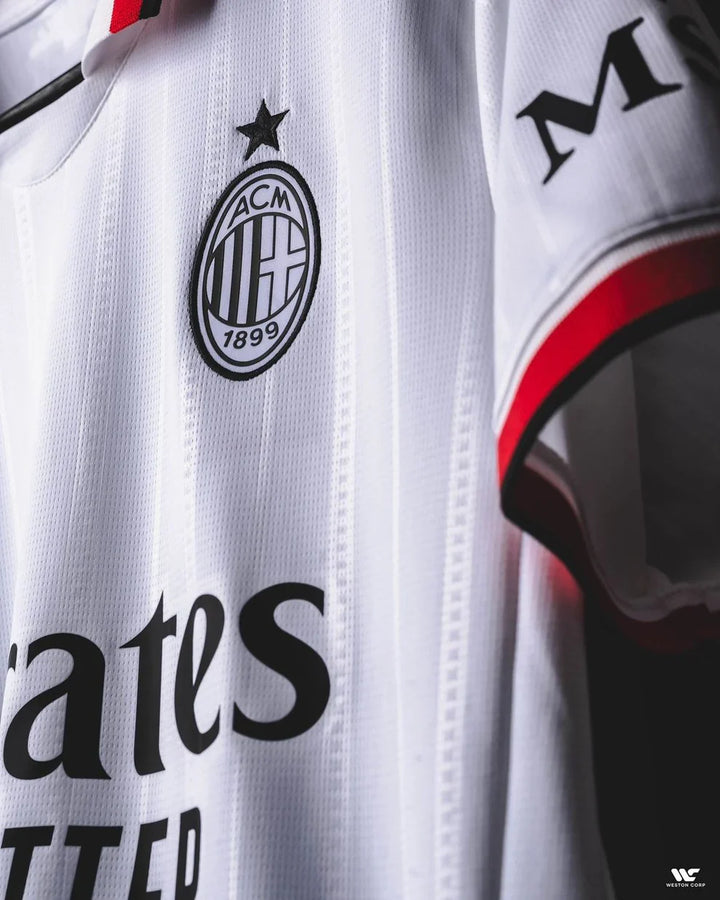 AC Milan away jersey 2024-25 featuring a white design with black and red accents