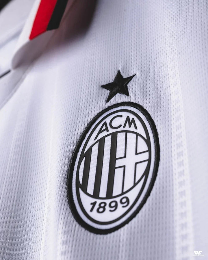 Close-up of AC Milan away jersey 2024 featuring the iconic club logo and star detail
