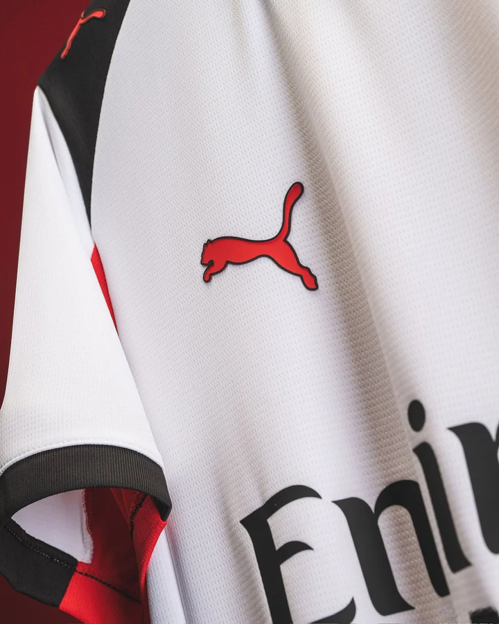 Close-up of AC Milan away jersey 2025-26 by Striker Store featuring Puma logo and white fabric