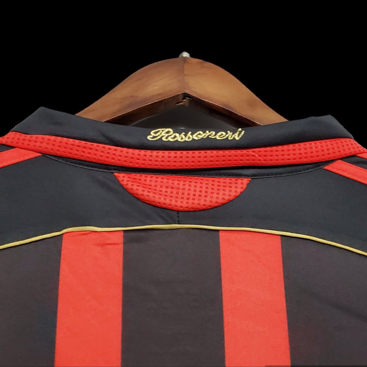 Back view of Retro AC Milan Jersey 2006-07 with red and black stripes and gold detailing