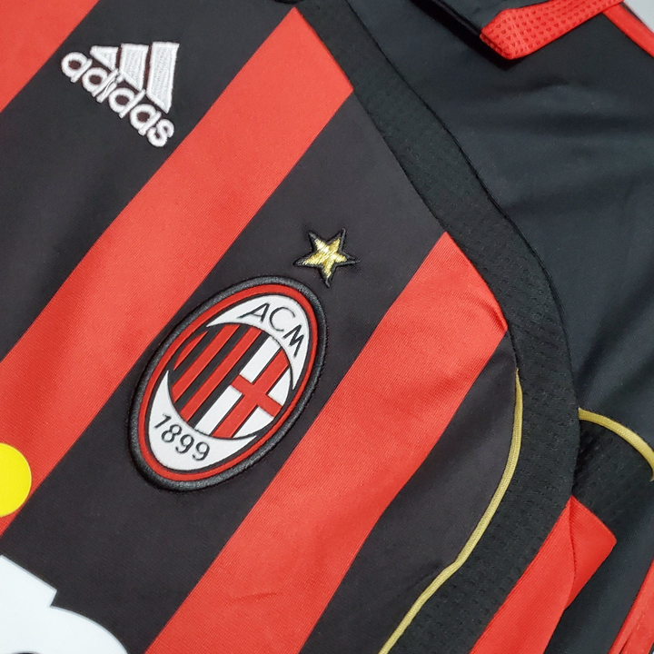 Retro AC Milan Jersey 2006-07 featuring red and black stripes with embroidered club badge