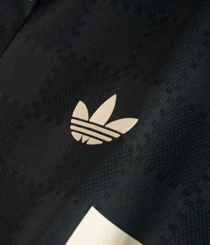 Striker Store Bayern Munich third jersey 2025-26 close up of black fabric with white Adidas trefoil logo