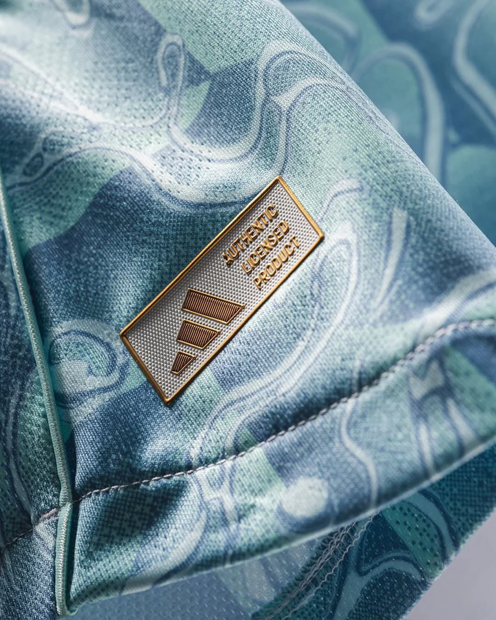 Close-up of Juventus away jersey 25-26 fabric showing Authentic Licensed Product gold badge