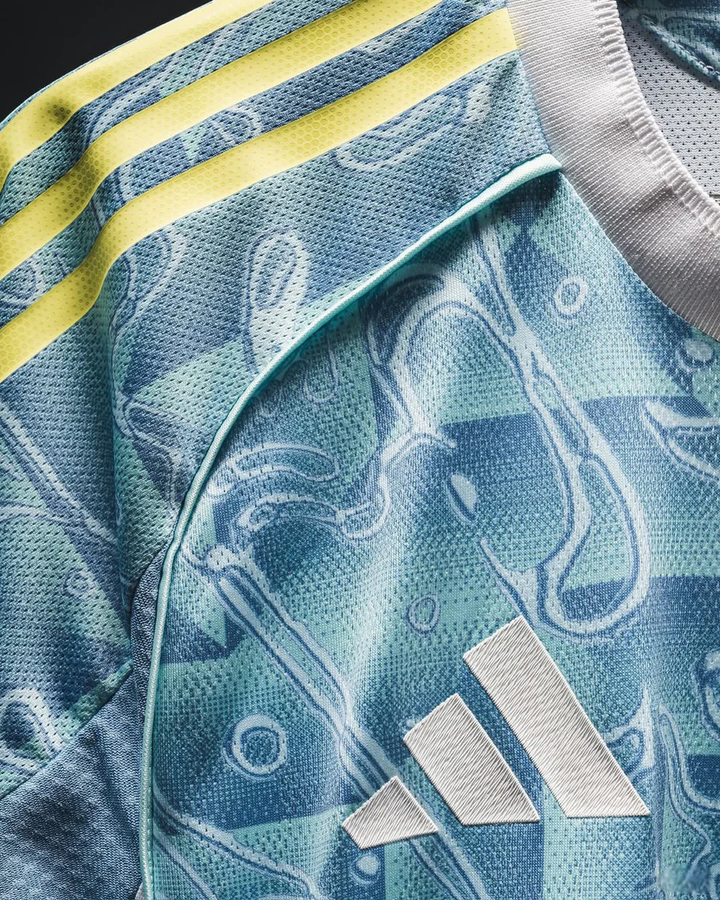 Close-up of Juventus away jersey 25-26 by Striker Store showing fabric texture and Adidas logo