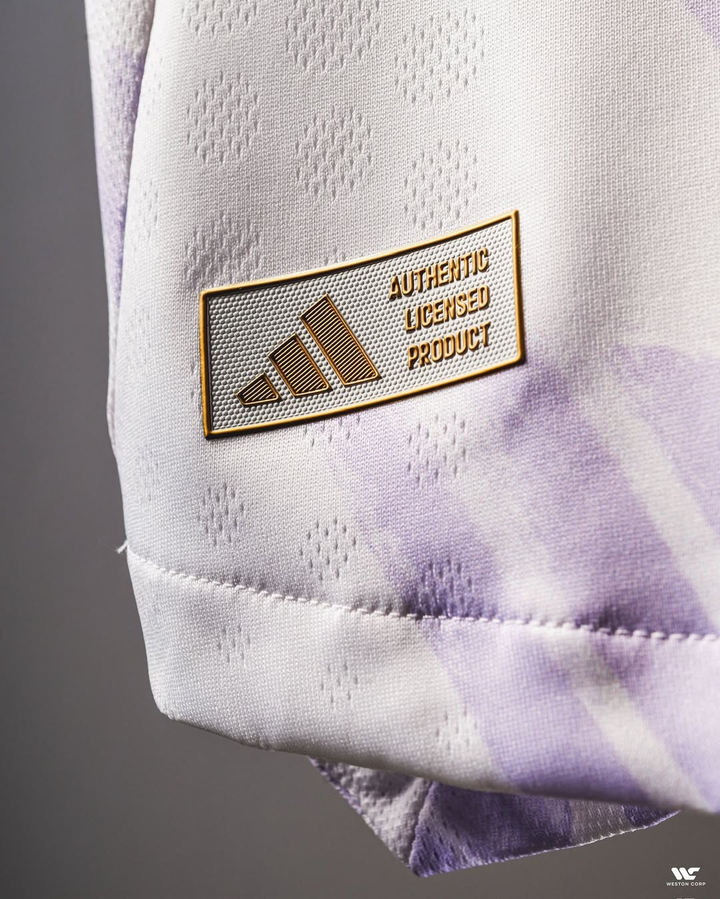 Close-up of Striker Store Manchester United away jersey 2025-26 with Adidas authentic licensed product badge