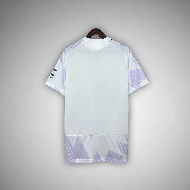 Back view of Manchester United away jersey 2025-26 in white with subtle purple graphic details by Striker Store