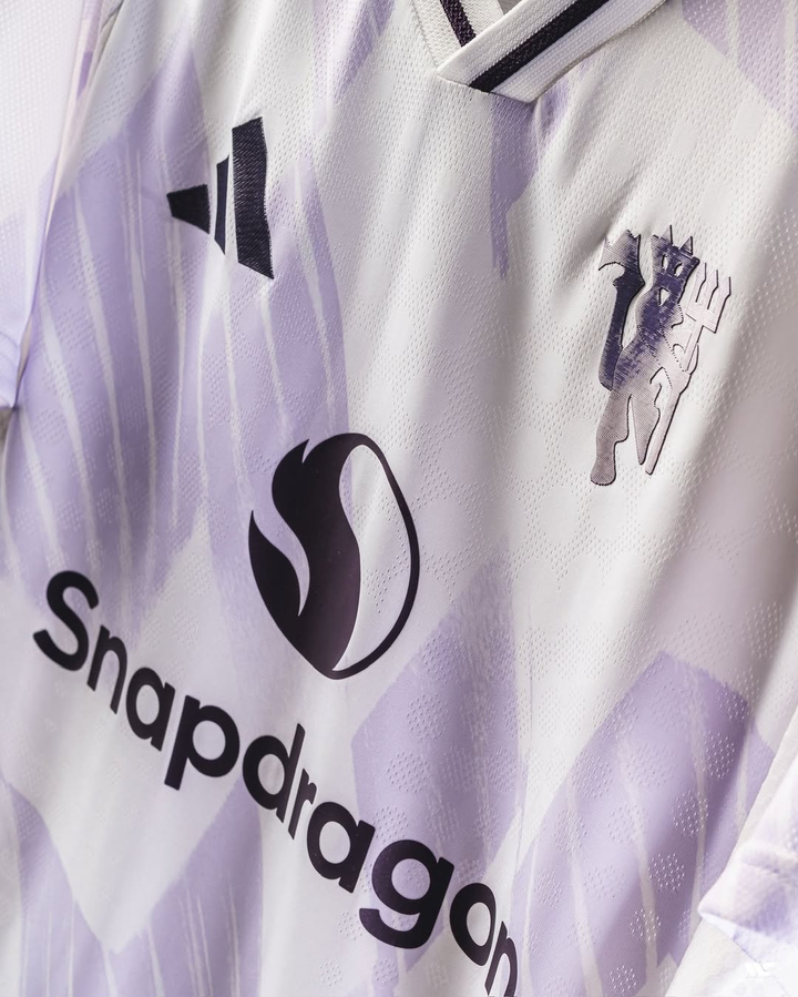 Striker Store Manchester United away jersey 2025-26 in white with black logo and Snapdragon sponsor