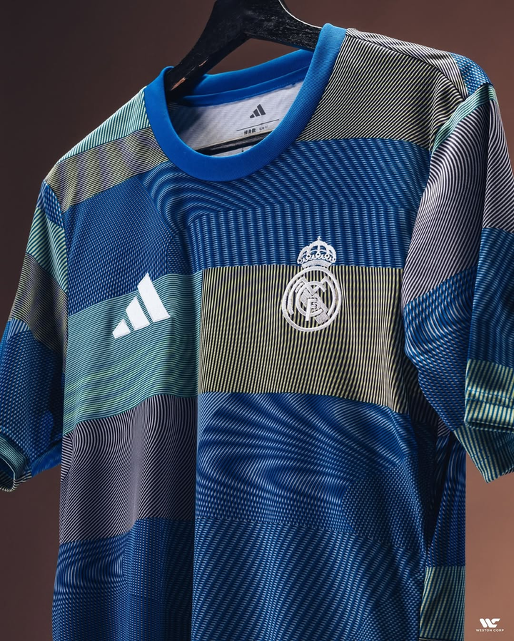 Real Madrid pre match jersey 2025 in blue with striped patterns and team crest on front