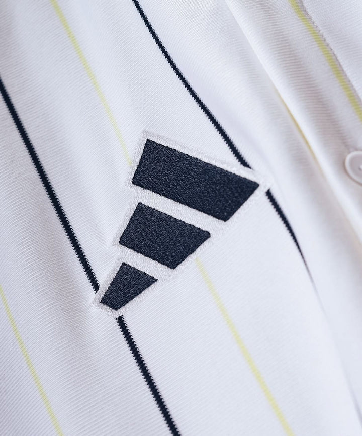 Striker Store Real Madrid special edition jersey 2025-26 close up of white pinstripe fabric with embroidered black three bar logo