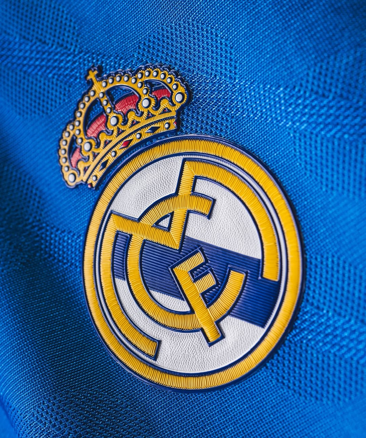 Close up embroidered Real Madrid crest on blue textured fabric Striker Store Real Madrid Third Jersey 2025-26