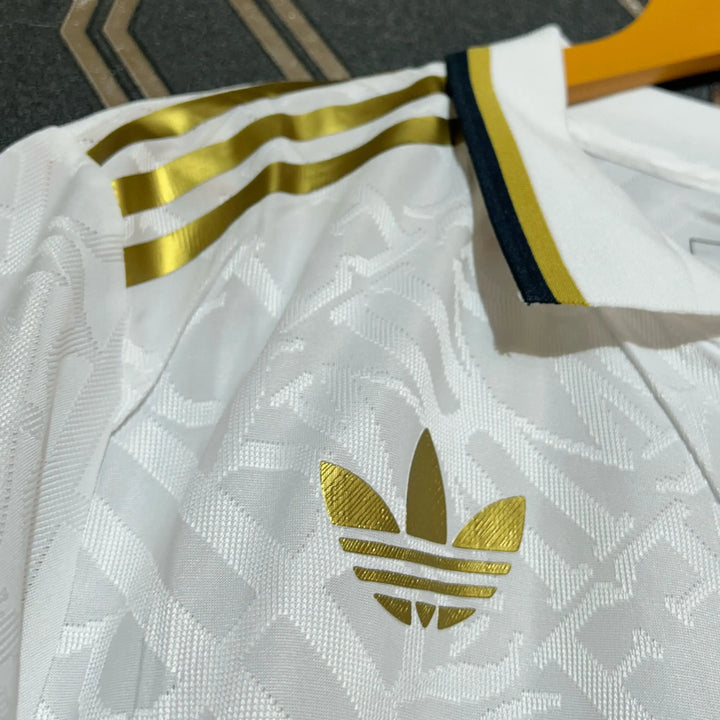 Real Madrid white gold jersey 2024-25 with gold Adidas logo and stripes on white textured fabric