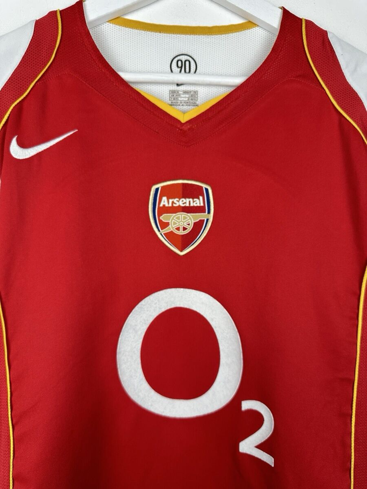 2004 Arsenal home jersey featuring the iconic red color and club logo on the front