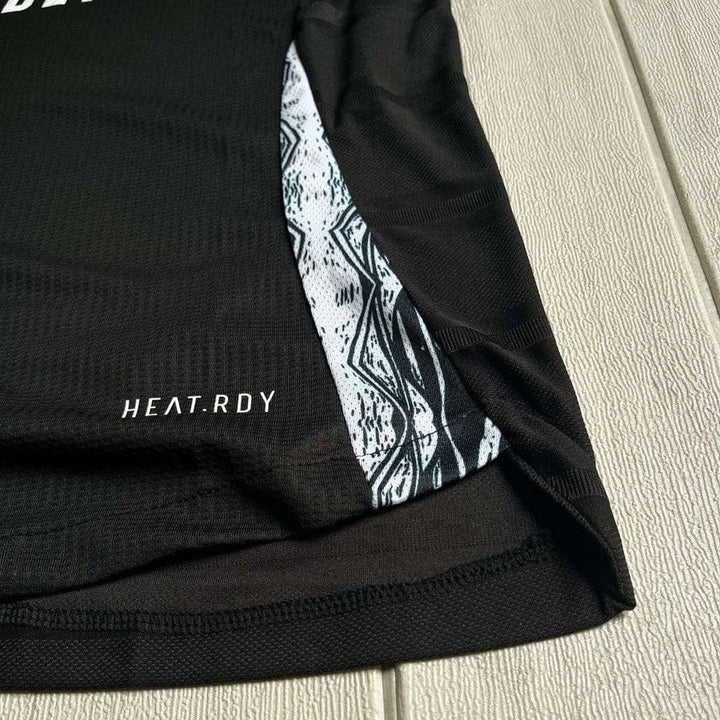Close-up of Arsenal away jersey 2024-25 showing the black design and heat-ready fabric details
