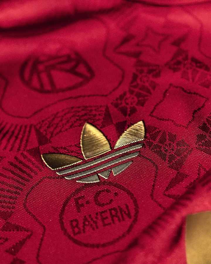 Close-up of the Bayern Munich 125th Anniversary Jersey featuring gold Adidas logo and club details