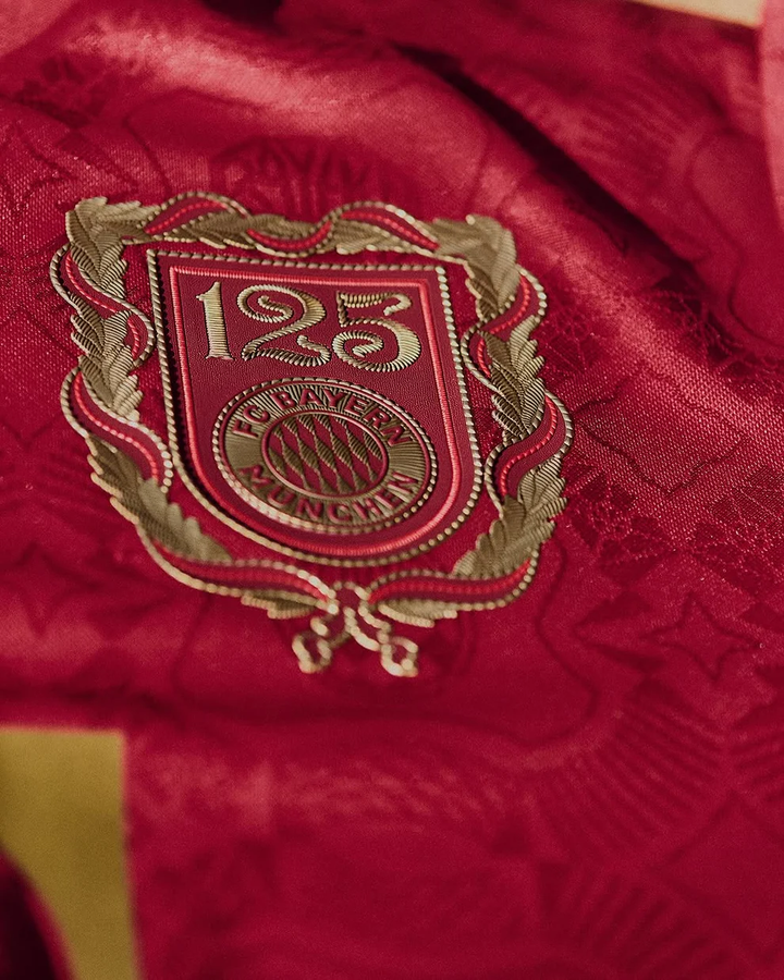 Close-up of Bayern Munich 125th Anniversary Jersey emblem featuring intricate detailing and bold colors