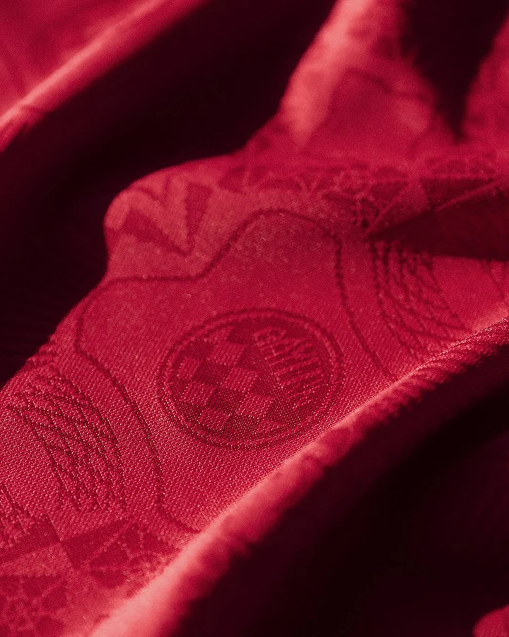 Close-up of the Bayern Munich 125th Anniversary Jersey fabric showcasing intricate designs and club logo