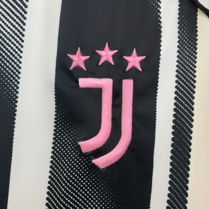 Close-up of Juventus Home Jersey 25-26 player featuring the iconic club logo in pink