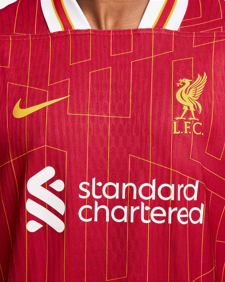 Liverpool home jersey 2024-25 featuring a striking red design with the club crest and Standard Chartered logo