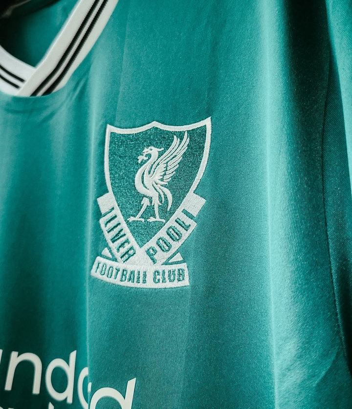 Close-up of Liverpool third jersey 2025-26 player version with club logo and vibrant colors