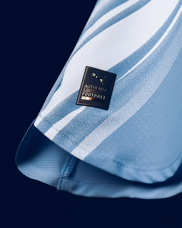 Close-up of the Manchester City 2025-26 Home Jersey featuring a special authenticity badge from Striker Store