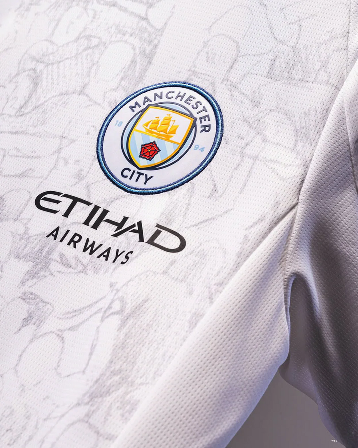 Close-up of Manchester City away jersey 2025-26 showing team crest and Etihad Airways logo