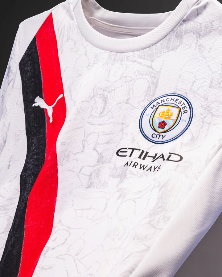 Striker Store Manchester City away jersey 2025-26 in white with red and black stripe and club crest