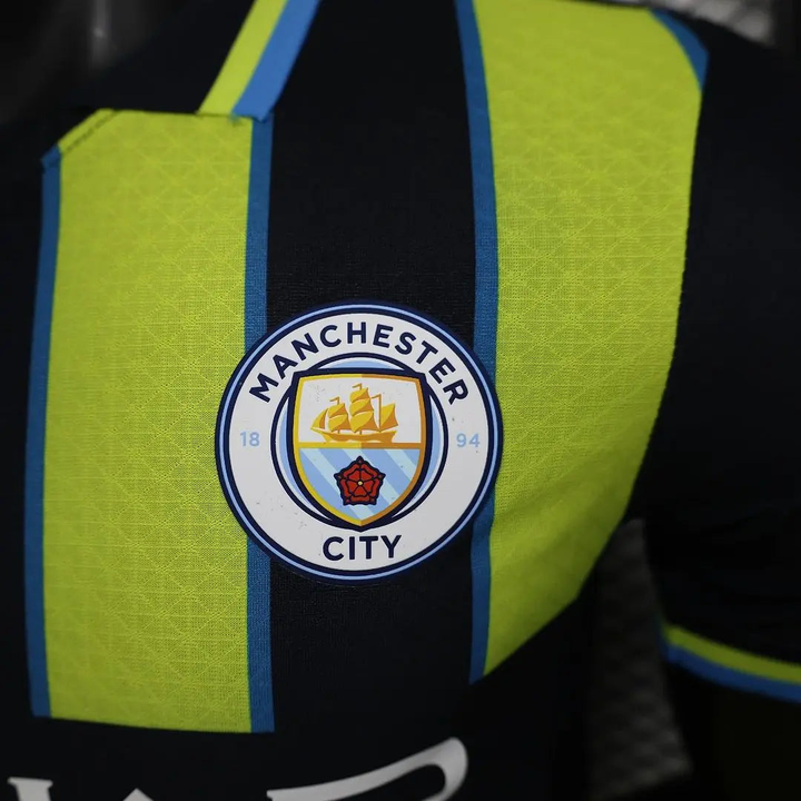 Manchester City away jersey player version featuring vibrant green and black design with club logo