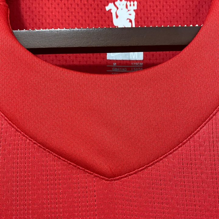 Detail view of the Manchester United 2007-08 Champions League jersey collar in red fabric