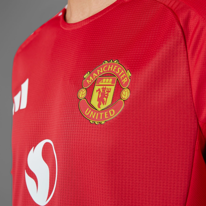 Manchester United jersey 2024-25 featuring the iconic club crest on a vibrant red background