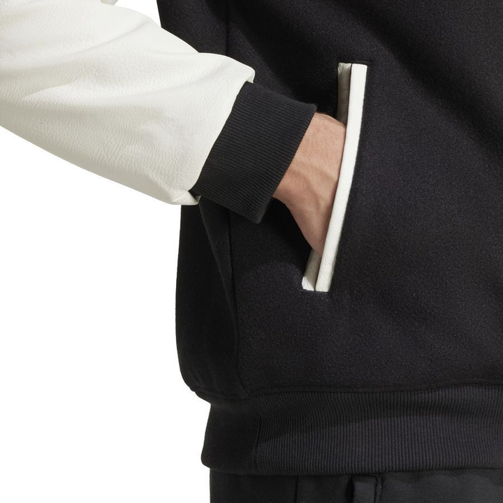 Striker Store Manchester United varsity jacket 2025-26 with stylish color-blocked design and side pockets