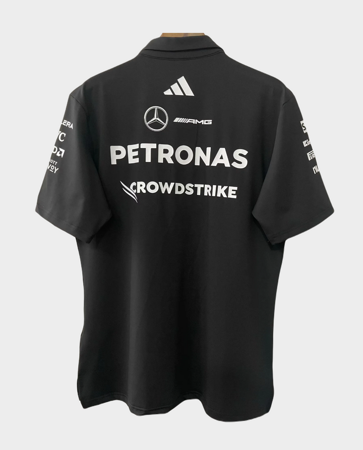 Back view of the Mercedes AMG Petronas F1 polo 2025 featuring sponsor logos in black and white