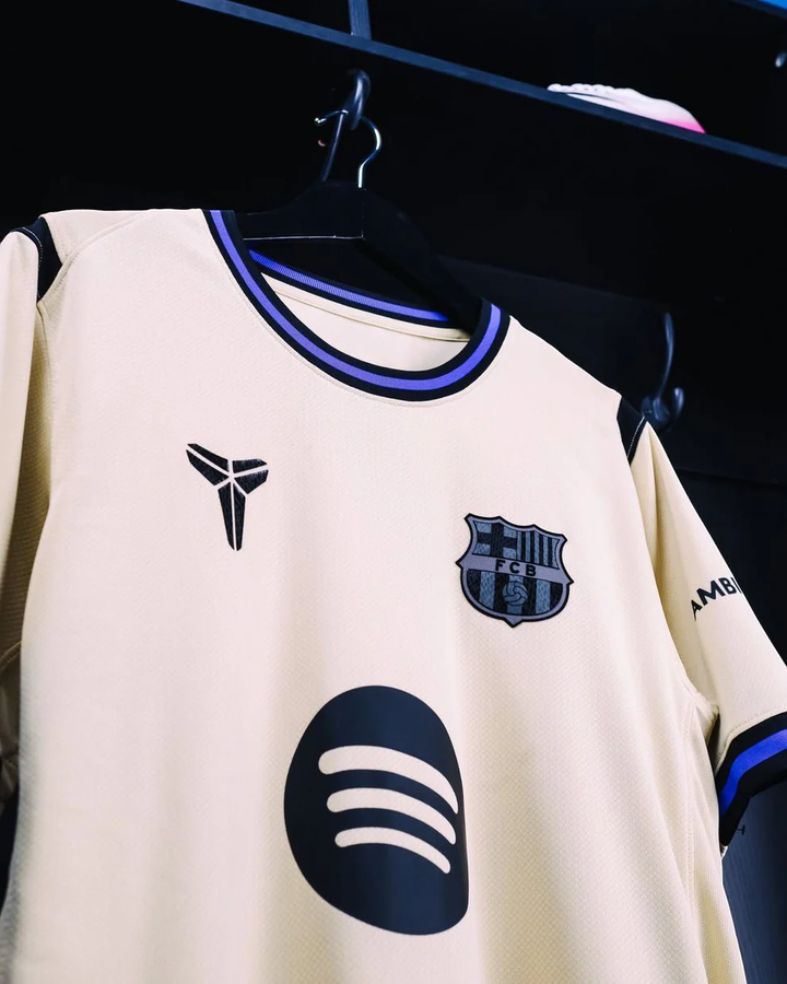Striker Store Barcelona away jersey 2025-26 cream with black crest Spotify logo and blue trim
