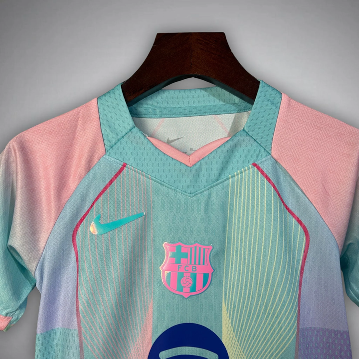 Striker Store FC Barcelona Blue Edition Jersey 2025-26 pastel aqua and pink Nike crest front view on hanger