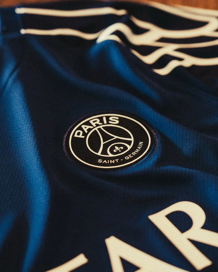 Close-up of PSG 2024 fourth jersey featuring the Paris Saint-Germain logo in detail