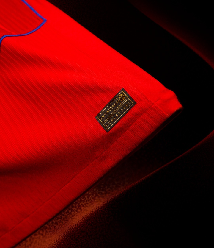 Detail of the Striker Store PSG third jersey 2025-26 pre order with vibrant red fabric and emblem