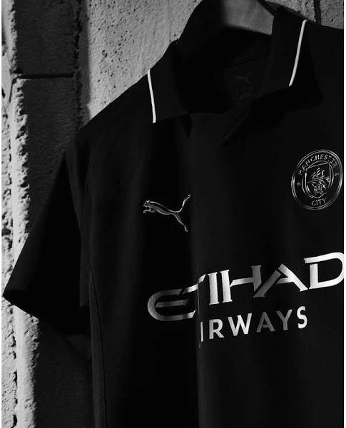 Striker Store Manchester City away jersey 2025 in black with white logo and Etihad Airways sponsor