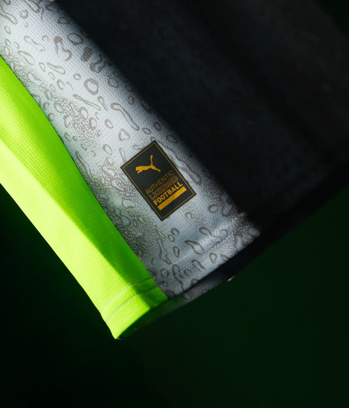 Striker Store close up of Manchester City Third Jersey 2025-26 hem with Puma Authentic Football label and neon trim