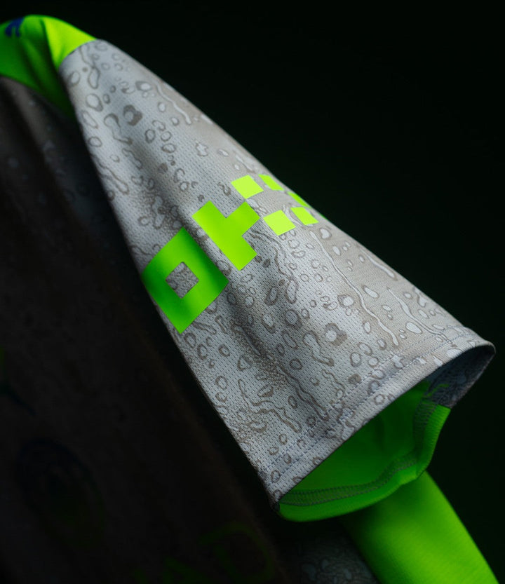 Striker Store close up of Manchester City Third Jersey 2025-26 gray sleeve with water droplet print and neon green trim