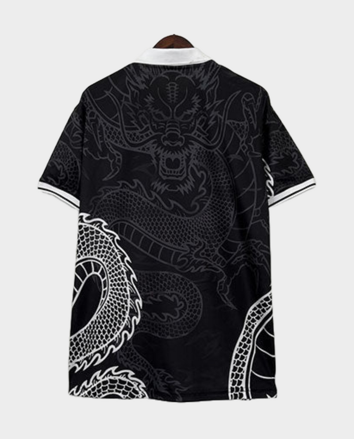Real Madrid Black Dragon Jersey featuring intricate dragon designs on a black background