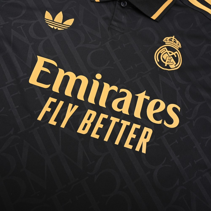 Real Madrid gold jersey 2023 featuring black fabric and gold accents with Emirates branding