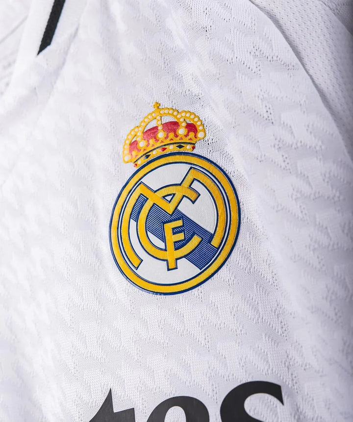 Close-up of Real Madrid jersey fan version featuring the iconic club crest and detailed fabric design