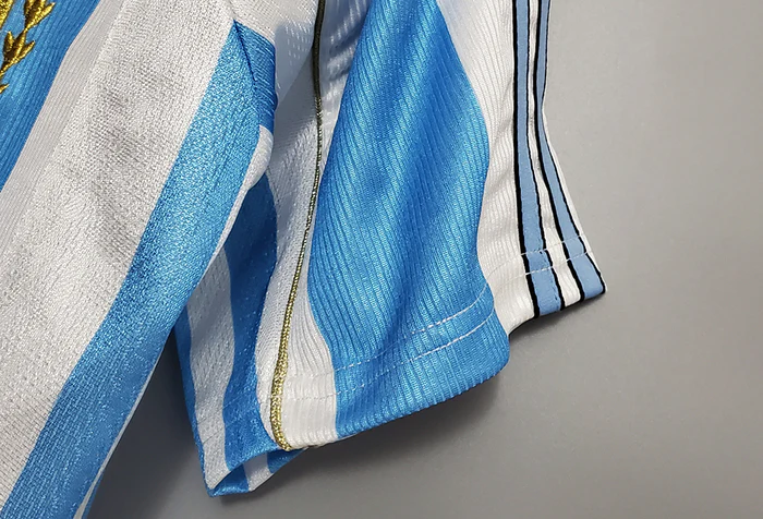Close-up of Retro Argentina 1998 jersey showcasing blue and white stripes with emblem detail