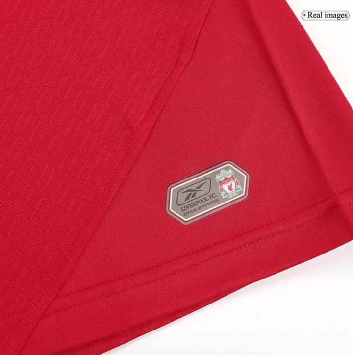 Retro Liverpool 2005 jersey fabric close-up showcasing club badge detail and vibrant red color