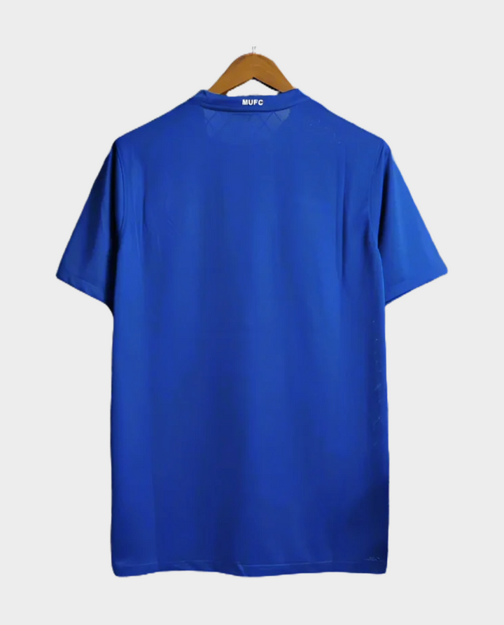 Back view of a blue Retro Manchester United jersey 2008-09 hanging on a wooden hanger