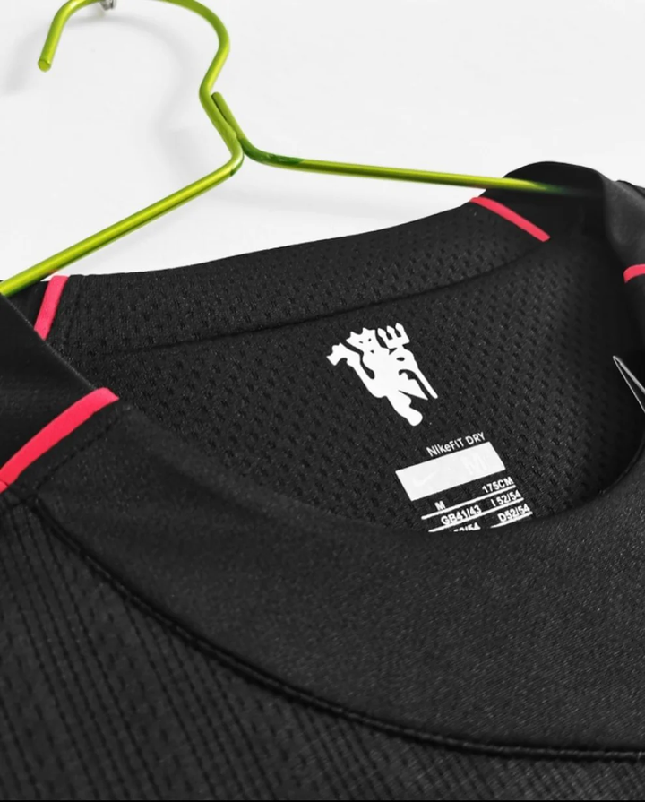 Close-up of the Retro Manchester United jersey 2008 neckline with tag details from Striker Store