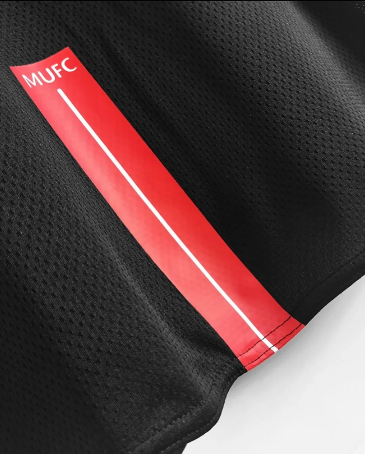 Close-up of Retro Manchester United jersey 2008 featuring MUFC logo and red detailing
