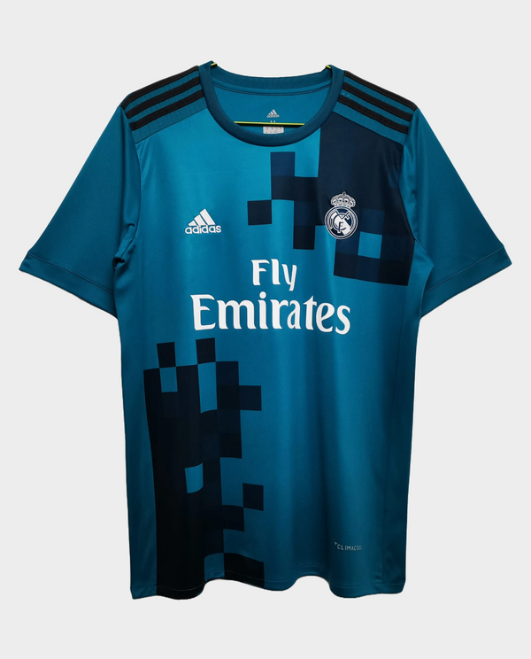 Retro Real Madrid 2017-18 jersey in teal blue with Emirates logo and geometric design